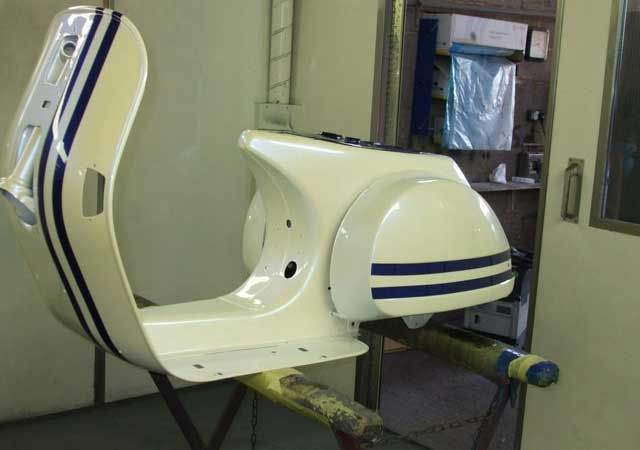 A scooters body getting painted