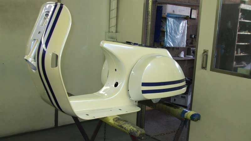 A scooters body getting painted